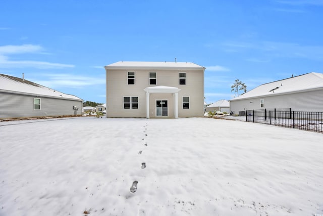 view of snow covered rear of property