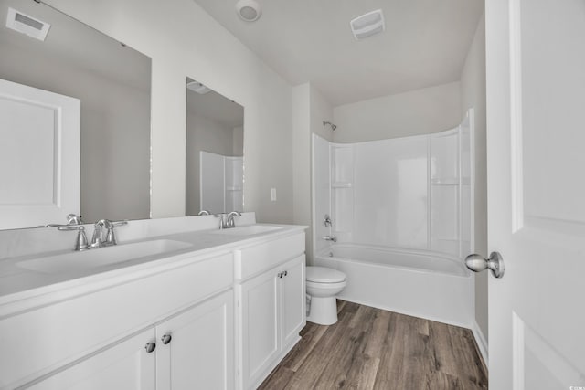 full bathroom with vanity, wood-type flooring, toilet, and shower / bath combination