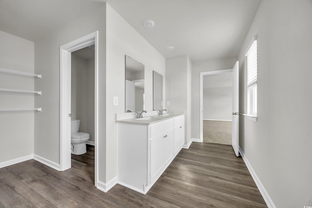 bathroom featuring hardwood / wood-style flooring, vanity, and toilet