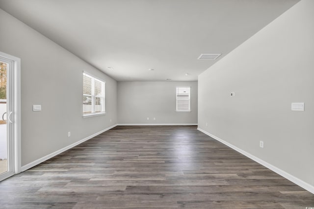 empty room with dark wood-type flooring