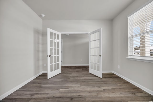 empty room with french doors and hardwood / wood-style flooring