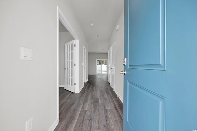 hall with dark wood-type flooring