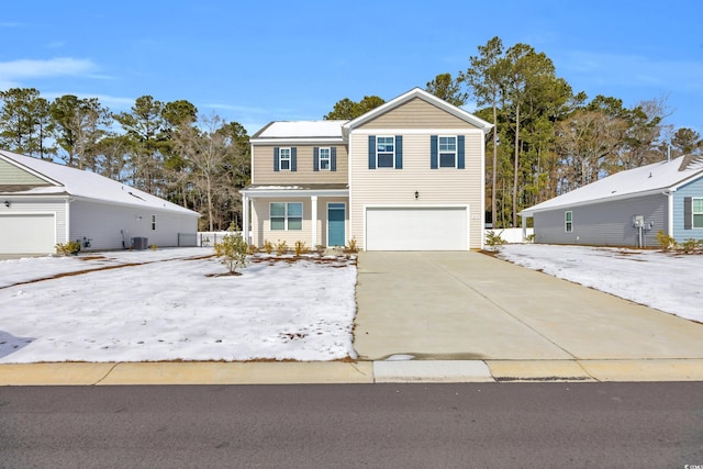 view of front property featuring a garage and central AC unit