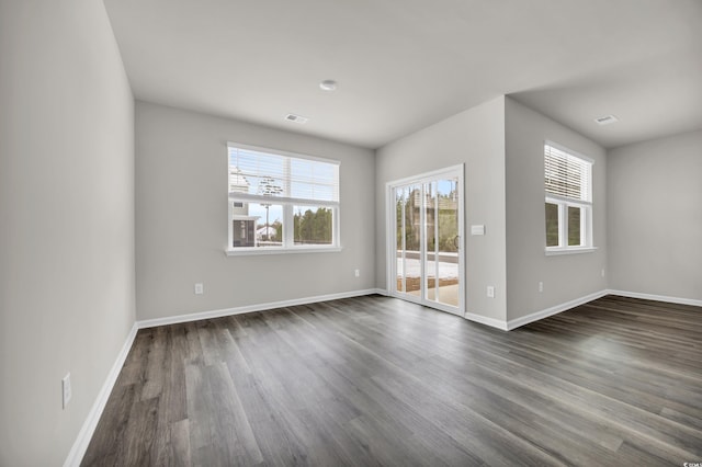 empty room featuring dark hardwood / wood-style flooring