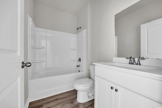 full bathroom with bathing tub / shower combination, vanity, toilet, and wood finished floors