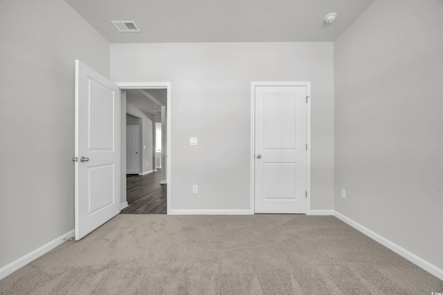 unfurnished bedroom with baseboards, visible vents, and carpet flooring