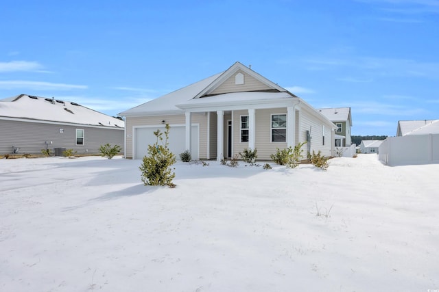 view of front of home featuring a garage and central air condition unit