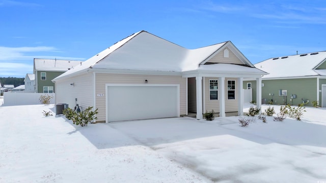 view of front of property with a garage and central air condition unit