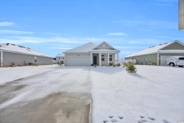 view of front of property featuring an attached garage and central air condition unit