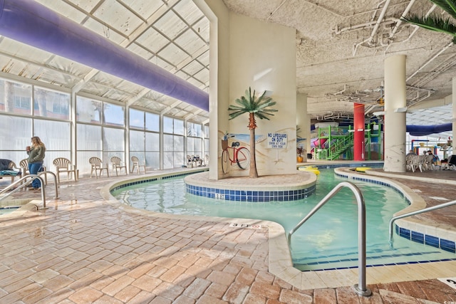 view of pool featuring a patio area and glass enclosure