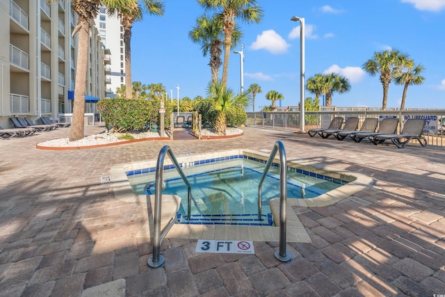 view of swimming pool featuring a community hot tub and a patio area