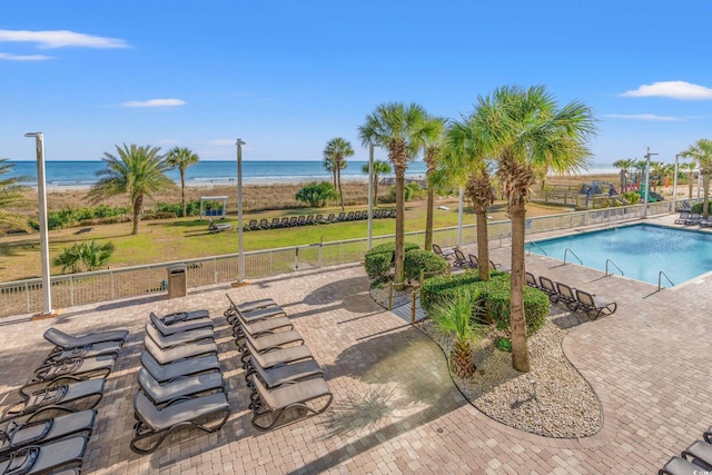 view of pool featuring a patio area and a water view