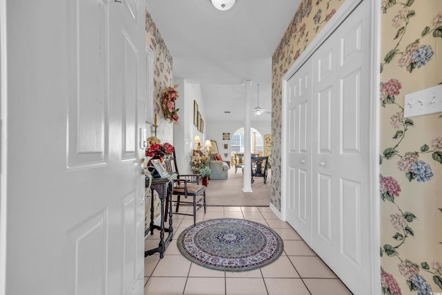 entryway featuring light tile patterned floors and ceiling fan