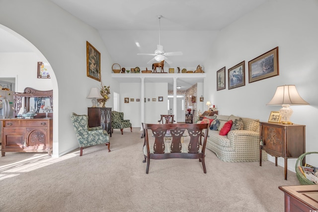 bedroom with high vaulted ceiling and light carpet