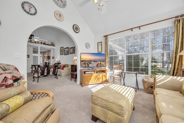 carpeted living room featuring ceiling fan and high vaulted ceiling