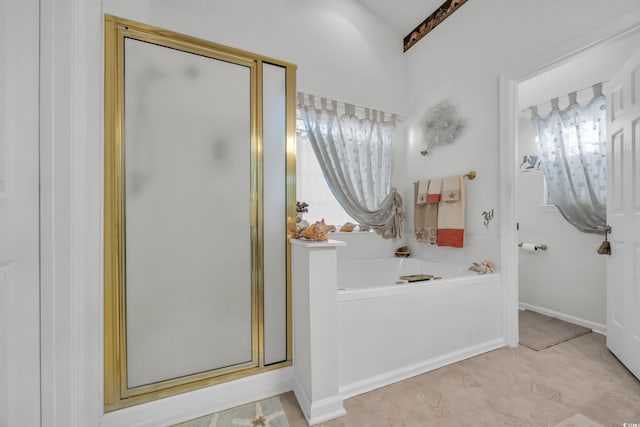 bathroom featuring separate shower and tub