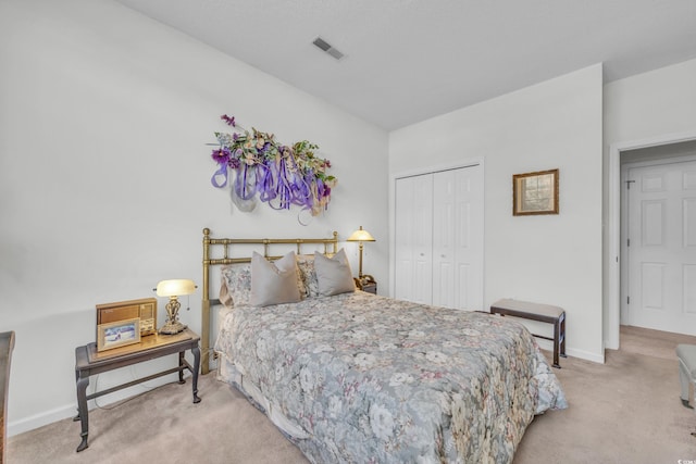 bedroom featuring light carpet and a closet