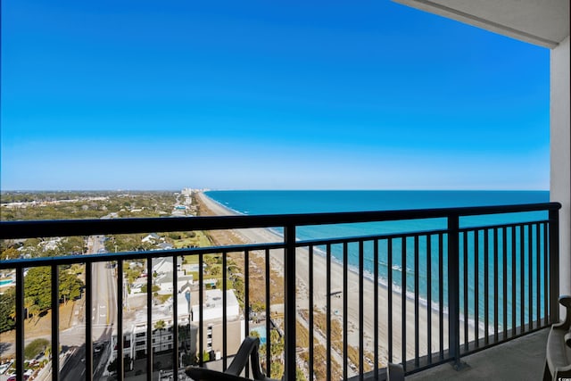 balcony featuring a beach view and a water view