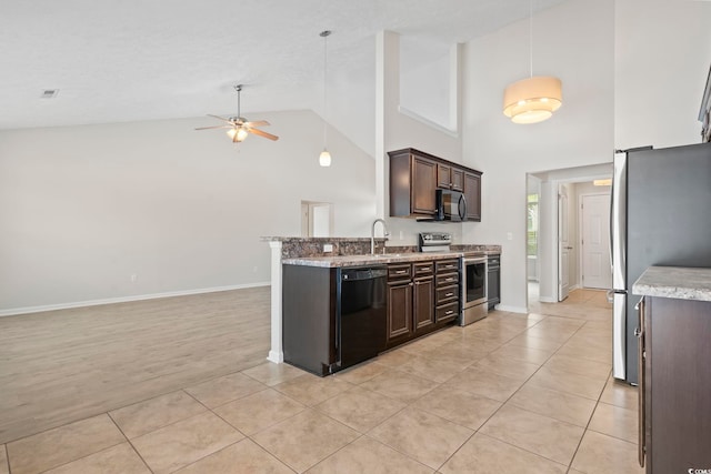 kitchen featuring dark brown cabinetry, decorative light fixtures, light tile patterned floors, and black appliances