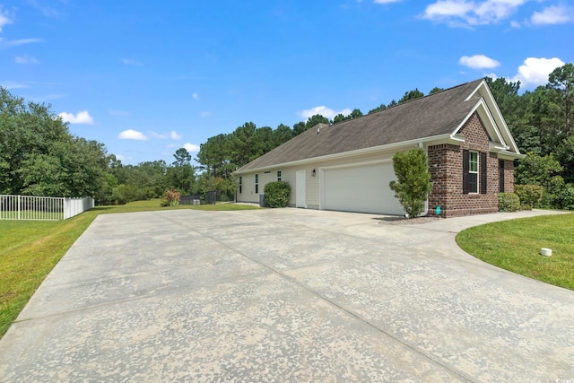 view of home's exterior featuring a garage and a lawn