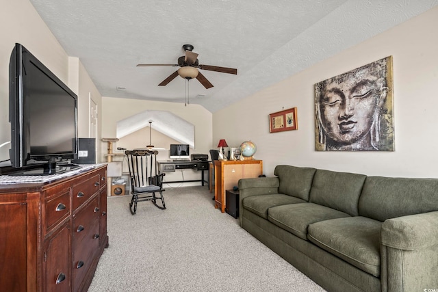 living room with ceiling fan, light colored carpet, vaulted ceiling, and a textured ceiling