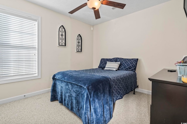 bedroom featuring light colored carpet and ceiling fan