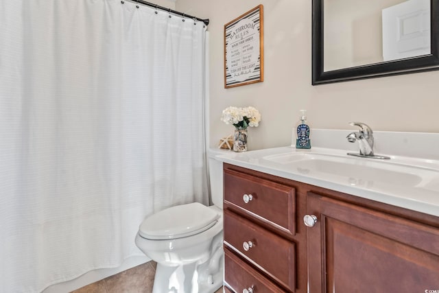 bathroom featuring vanity, tile patterned flooring, and toilet