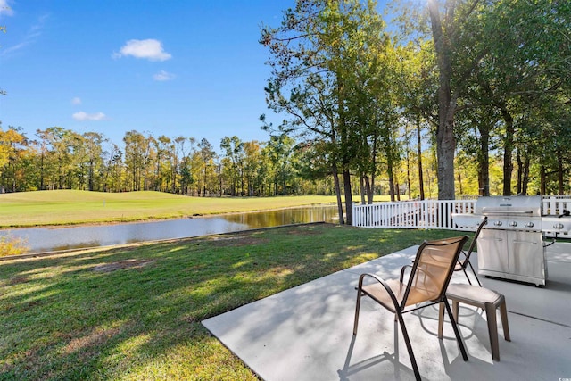 exterior space featuring a water view and area for grilling