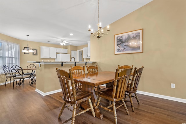 dining room featuring sink, ceiling fan with notable chandelier, and dark hardwood / wood-style floors