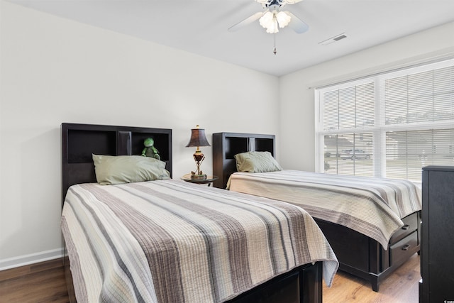 bedroom with wood-type flooring and ceiling fan