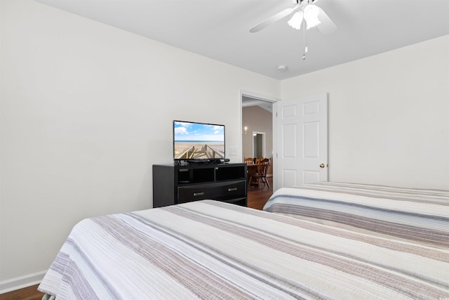 bedroom featuring dark hardwood / wood-style flooring and ceiling fan