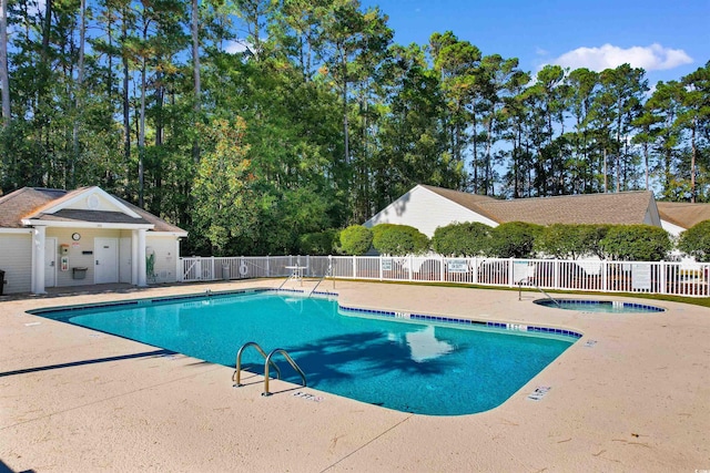 view of swimming pool with a community hot tub and a patio