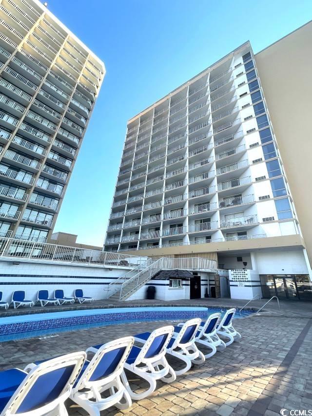 view of building exterior featuring a community pool