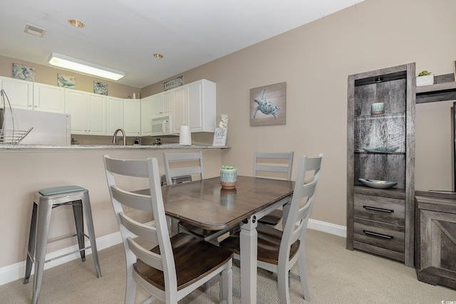 view of carpeted dining space