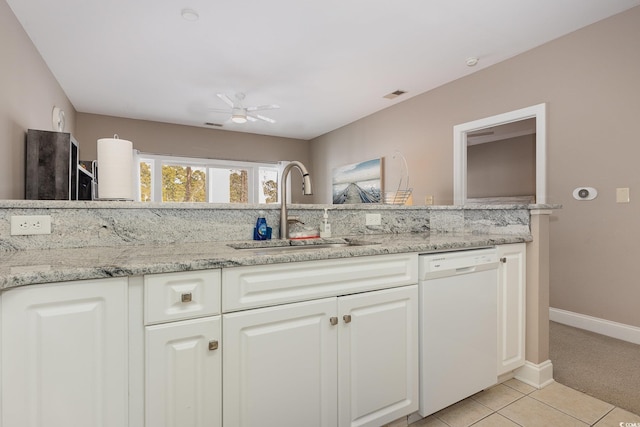 kitchen with sink, white cabinetry, white dishwasher, ceiling fan, and light stone countertops