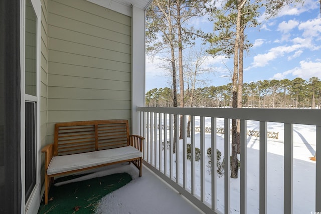 view of snow covered back of property