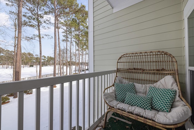 view of snow covered back of property