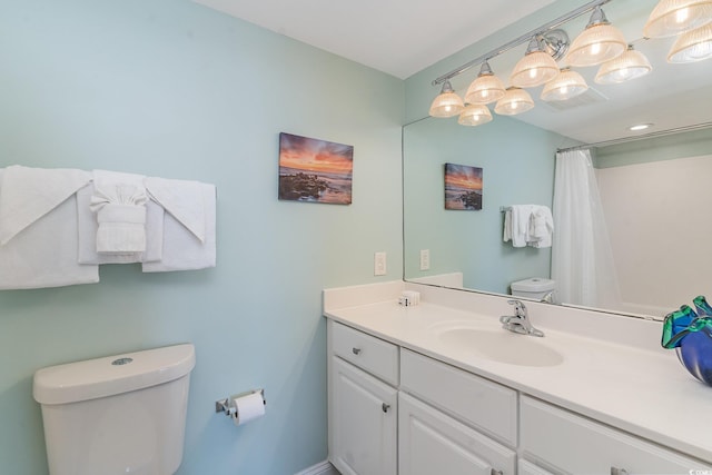 bathroom with a shower with curtain, vanity, and toilet