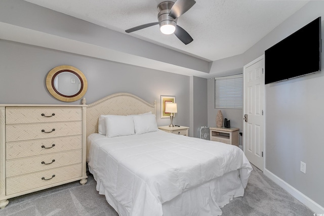 bedroom featuring carpet floors, a textured ceiling, and ceiling fan