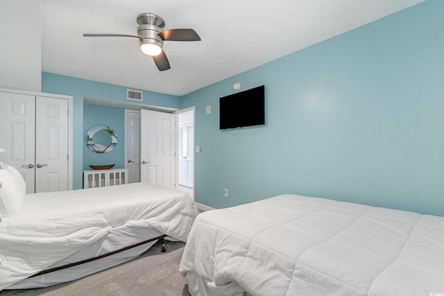 bedroom featuring carpet floors, a closet, and ceiling fan