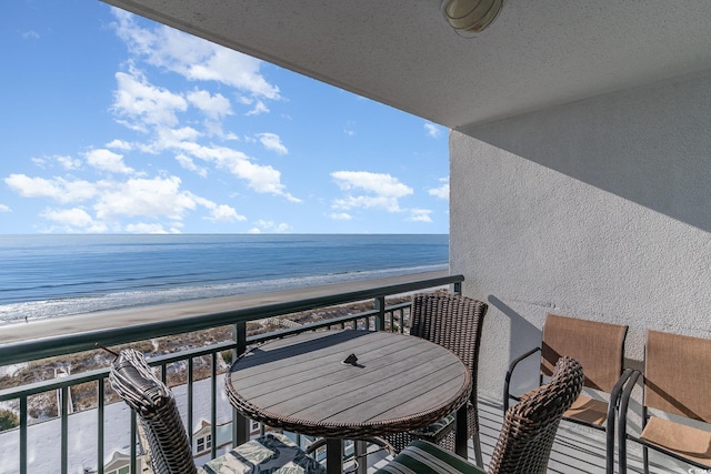 balcony featuring a water view and a view of the beach