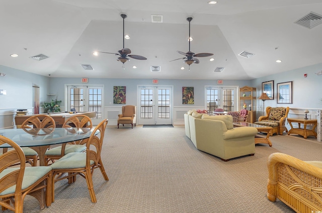 living room with lofted ceiling, light carpet, and french doors