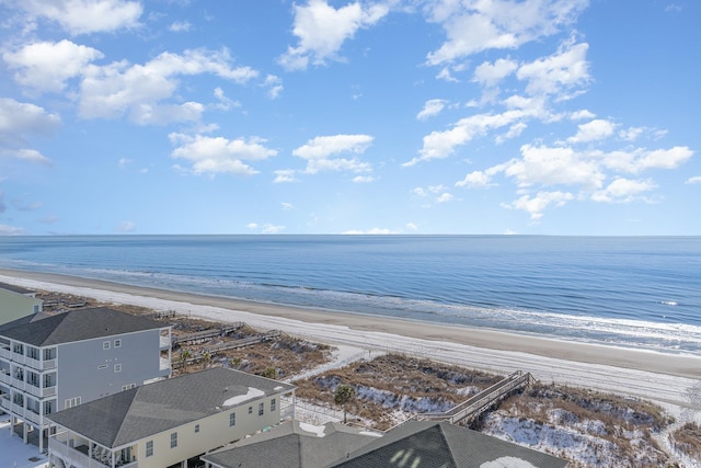 birds eye view of property featuring a water view and a beach view