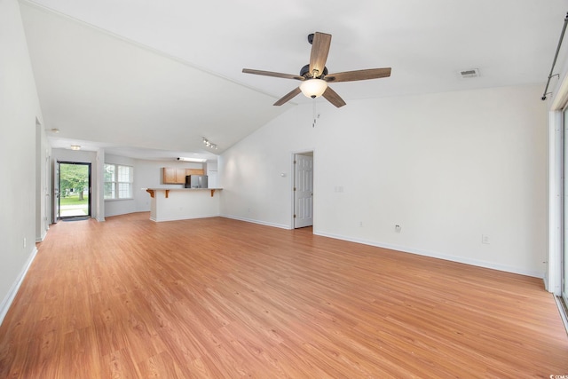 unfurnished living room with vaulted ceiling, ceiling fan, and light wood-type flooring