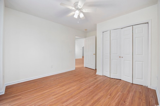 unfurnished bedroom with ceiling fan, light hardwood / wood-style floors, and a closet