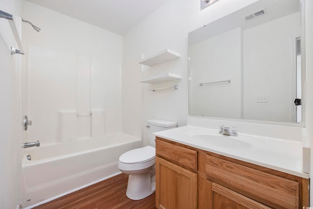 full bathroom with vanity, hardwood / wood-style flooring, shower / washtub combination, and toilet