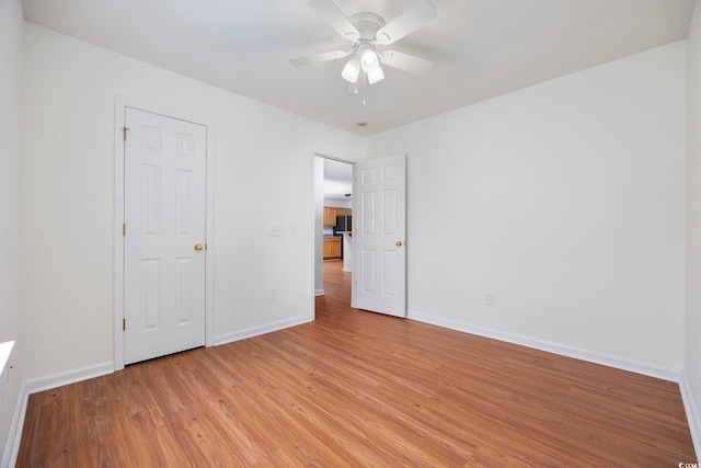 unfurnished bedroom with ceiling fan and light wood-type flooring