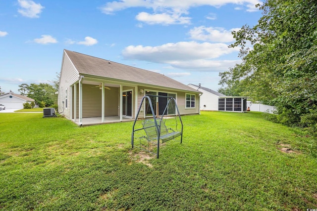 back of property with a patio and a lawn