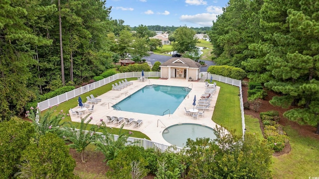 view of pool featuring a patio and a lawn