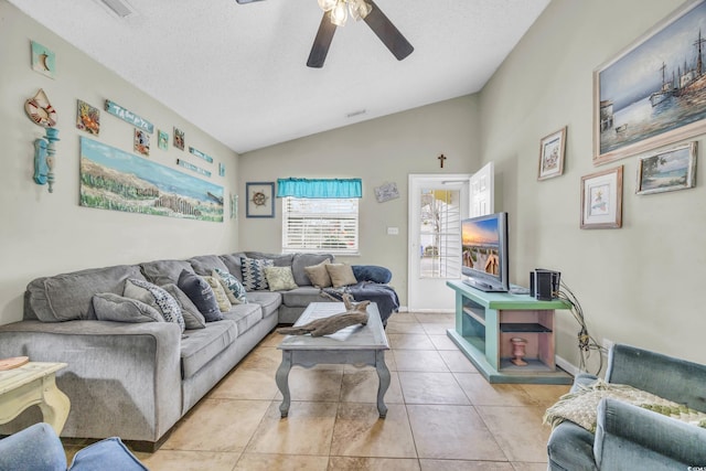 living room with light tile patterned flooring, ceiling fan, lofted ceiling, and a textured ceiling